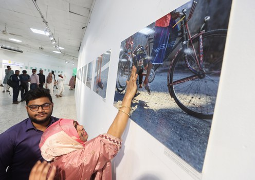 Nazma Akter Nasima, who attended a BenarNews-sponsored event at the Bangladesh National Museum in Dhaka on Nov. 19, 2024, touches a photo of her 17-year-old son who was fatally shot during a protest on Aug. 4.