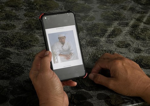 Najib Lep looks at a photo sent by his brother Mohammed Nazir bin Lep, who had pleaded guilty before a U.S. military tribunal to terror charges tied to the 2002 Bali bombings, in Muar, Johor, Malaysia, Sept. 30, 2023.