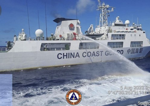 A Chinese coast guard ship uses a water cannon on a Philippine Coast Guard vessel near the Philippine-occupied Second Thomas Shoal, South China Sea as they block its path during a resupply mission, Aug. 5, 2023.