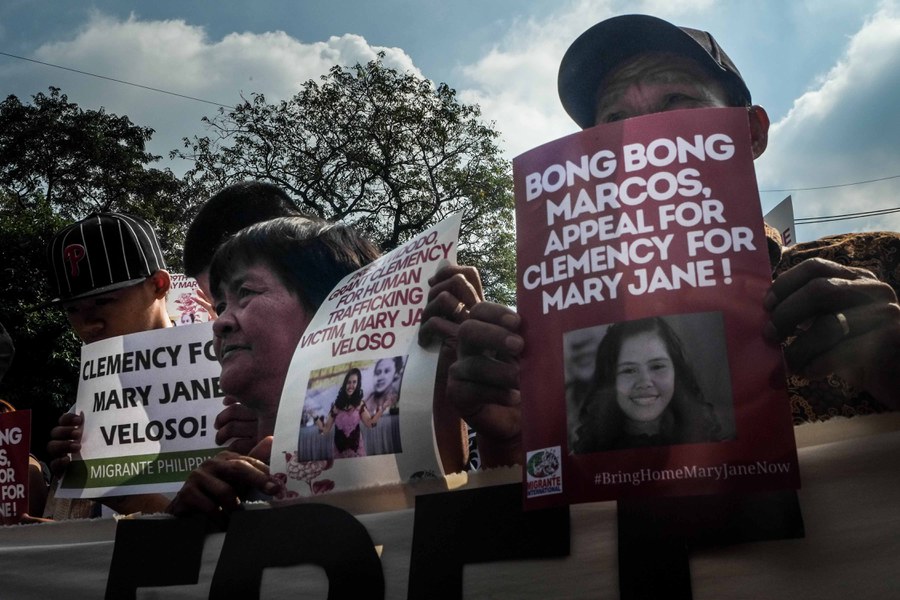 Cesar (right with cap) and Celia Veloso (center), parents of jailed migrant worker Mary Jane Veloso, join a rally in Manila appealing for her release, July 10, 2023.