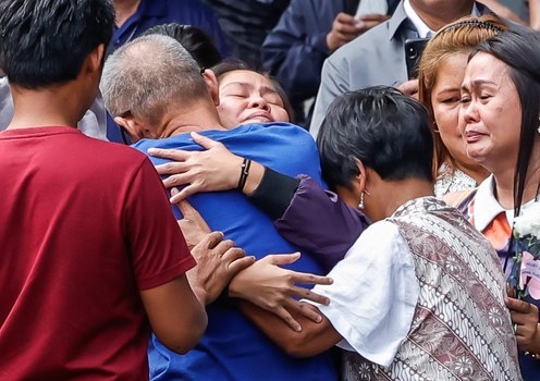 Filipina migrant worker Mary Jane Veloso (center) hugs her father upon arriving at the Correctional Institution for Women in Manila, as relatives look on, following her transfer from an Indonesian prison, Dec. 18, 2024.