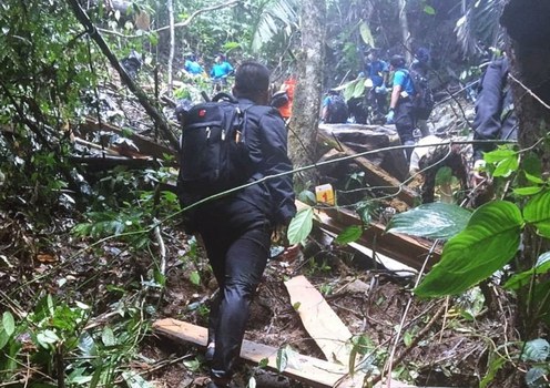 Investigators and forensic officers enter the scene of fatal shootings at the Khao Ta We mountain range in Ra-ngae district, Narathiwat province, southern Thailand, Dec. 17, 2019.