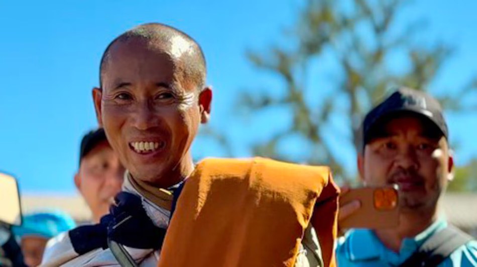 Vietnamese monk Thich Minh Tue is followed by his bodyguard Doan Van Bau (right) as he walks through Thailand on his way to India, January 2025.