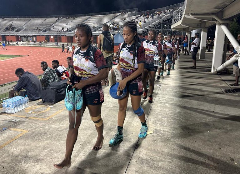 Anggota tim rugbi tujuh putri Papua Koteka berjalan di stadiun dimana turnamen PNG Rookies 7 diselenggarakan pada 17 Desember 2023 di Port Moresby, Papua Nugini. [Harlyne Joku/BenarNews]